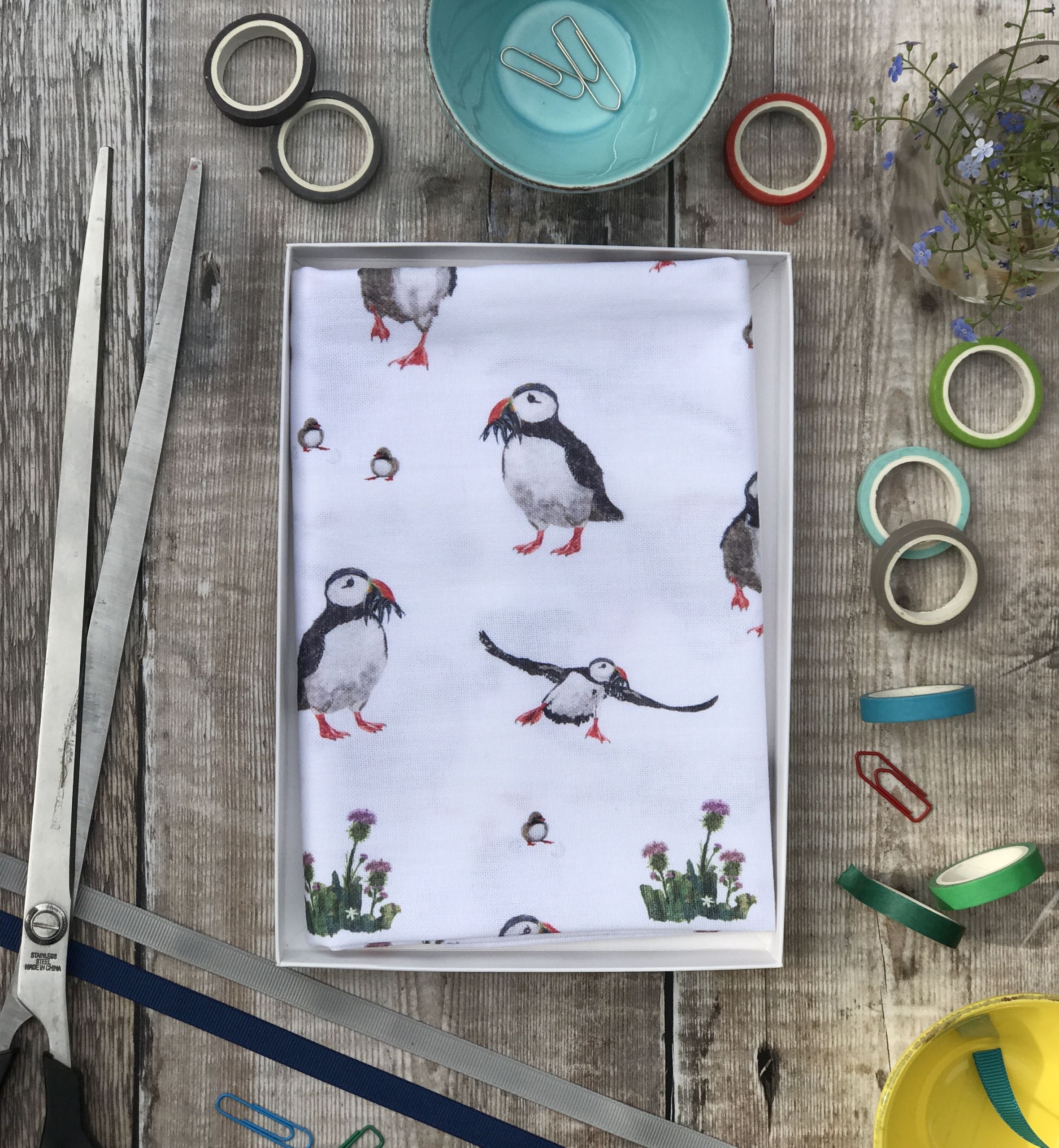 tea towel folded in an open box puffin repeat