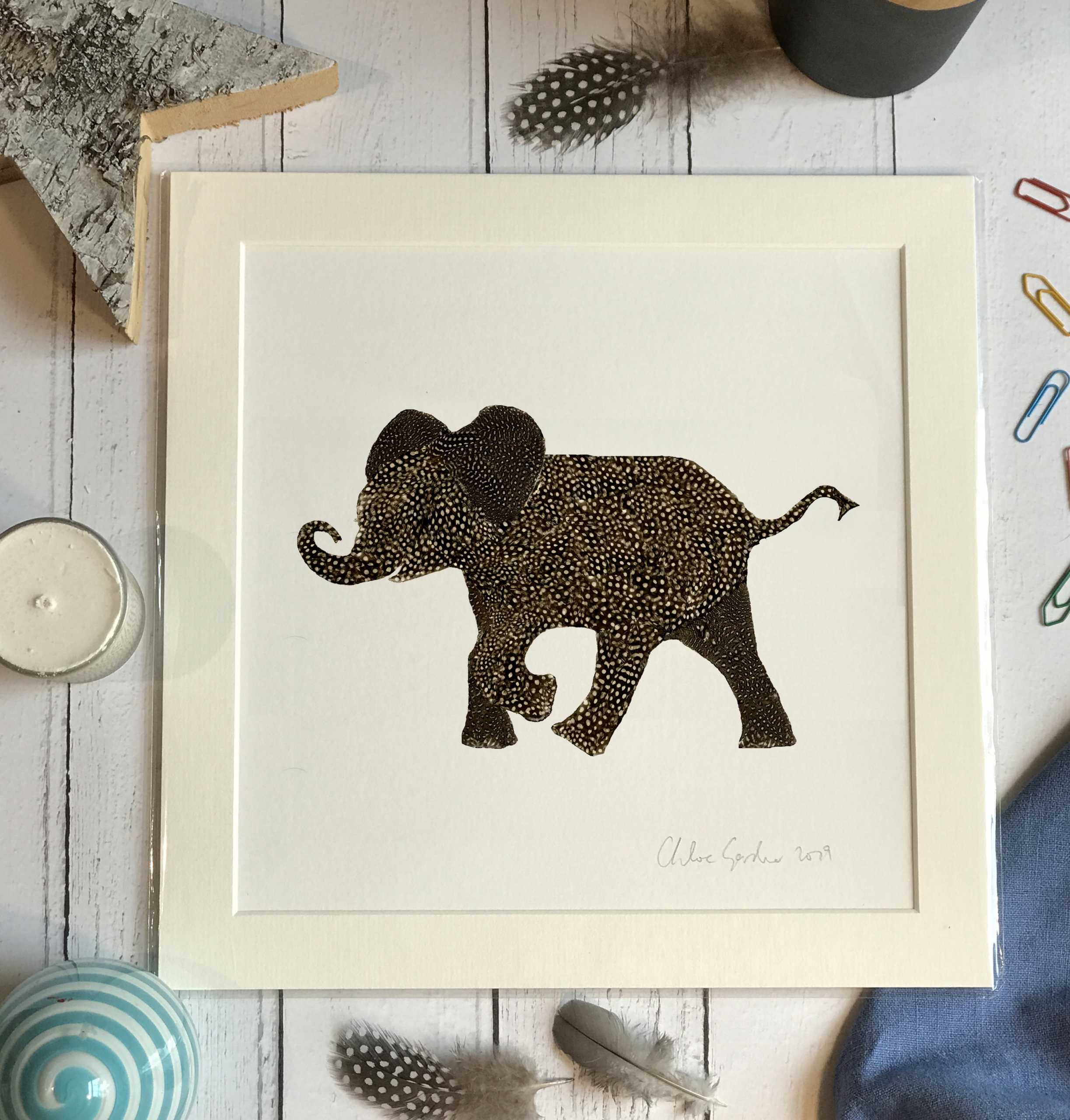 Unframed Print - Square in a mount and bag for 12 inch frame - feather baby elephant with a curved trunk  (Avail:1 04/26)