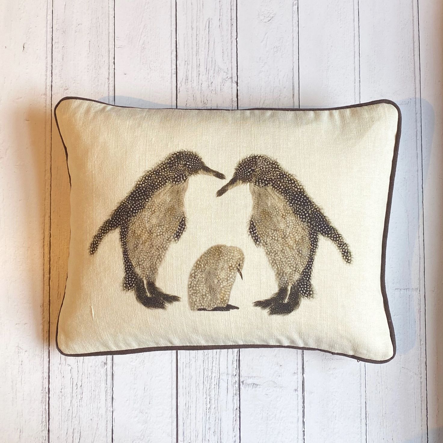cushion two penguins and a baby on white wood