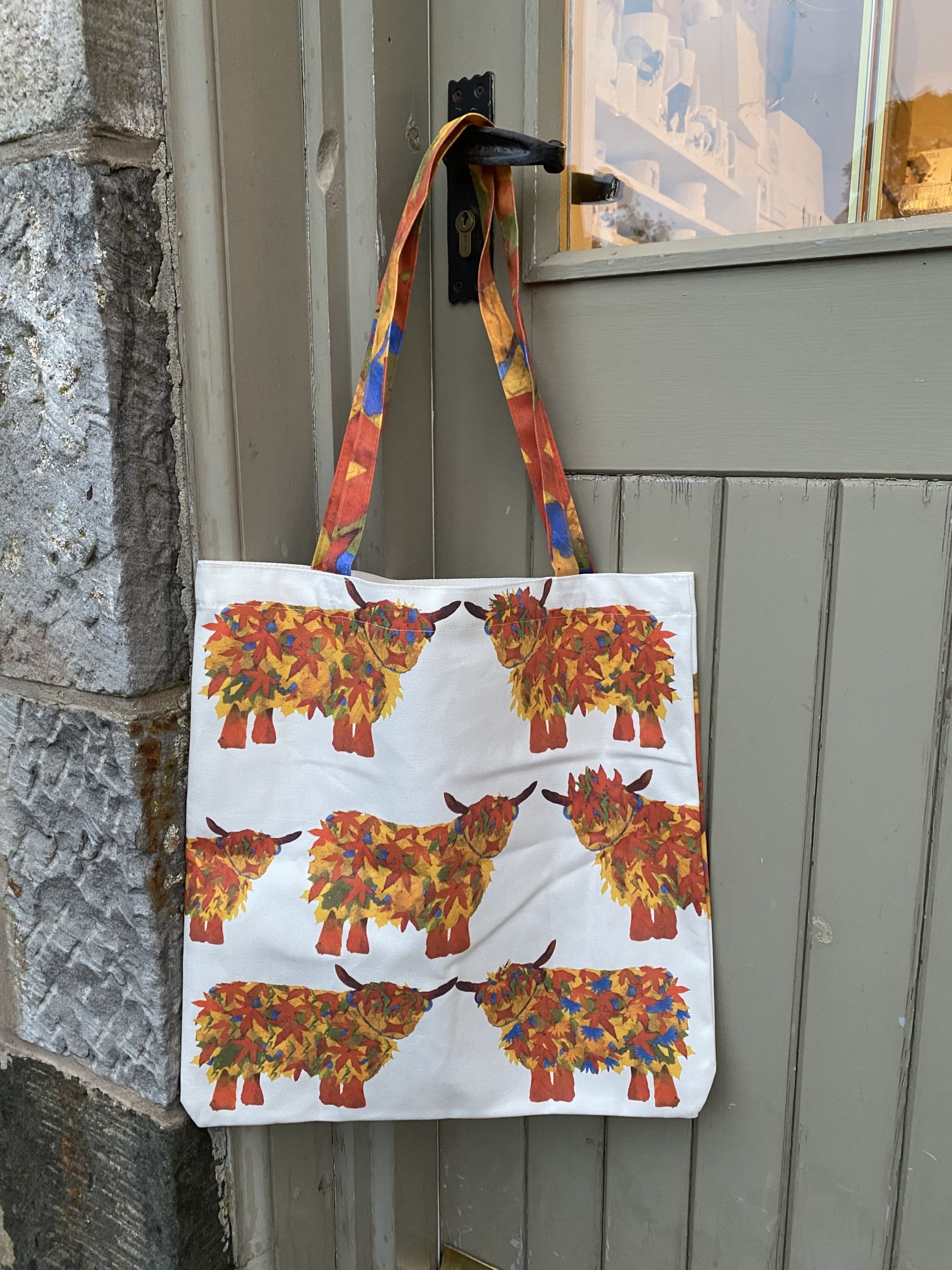 Colourful Leaf Highland Cow Shopper Bag by Chloe Gardner Colourful Leaf Highland Cow Shopper Bag with Orange Red and Green Autumn leaves forming a Cow design, printed onto a large tote style cotton Canvas bag