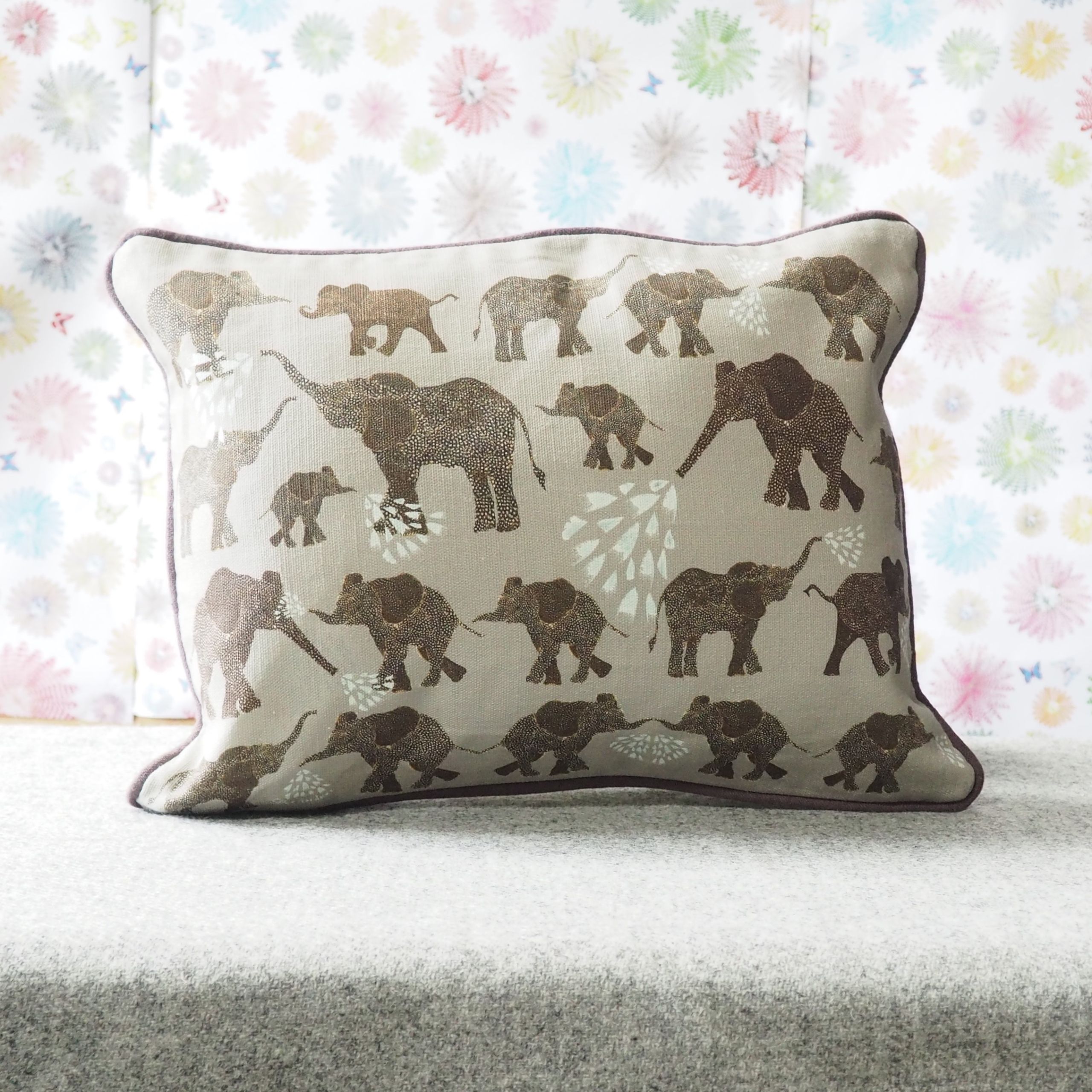 Elephant repeat on grey rectangle cushion by Chloe Gardner