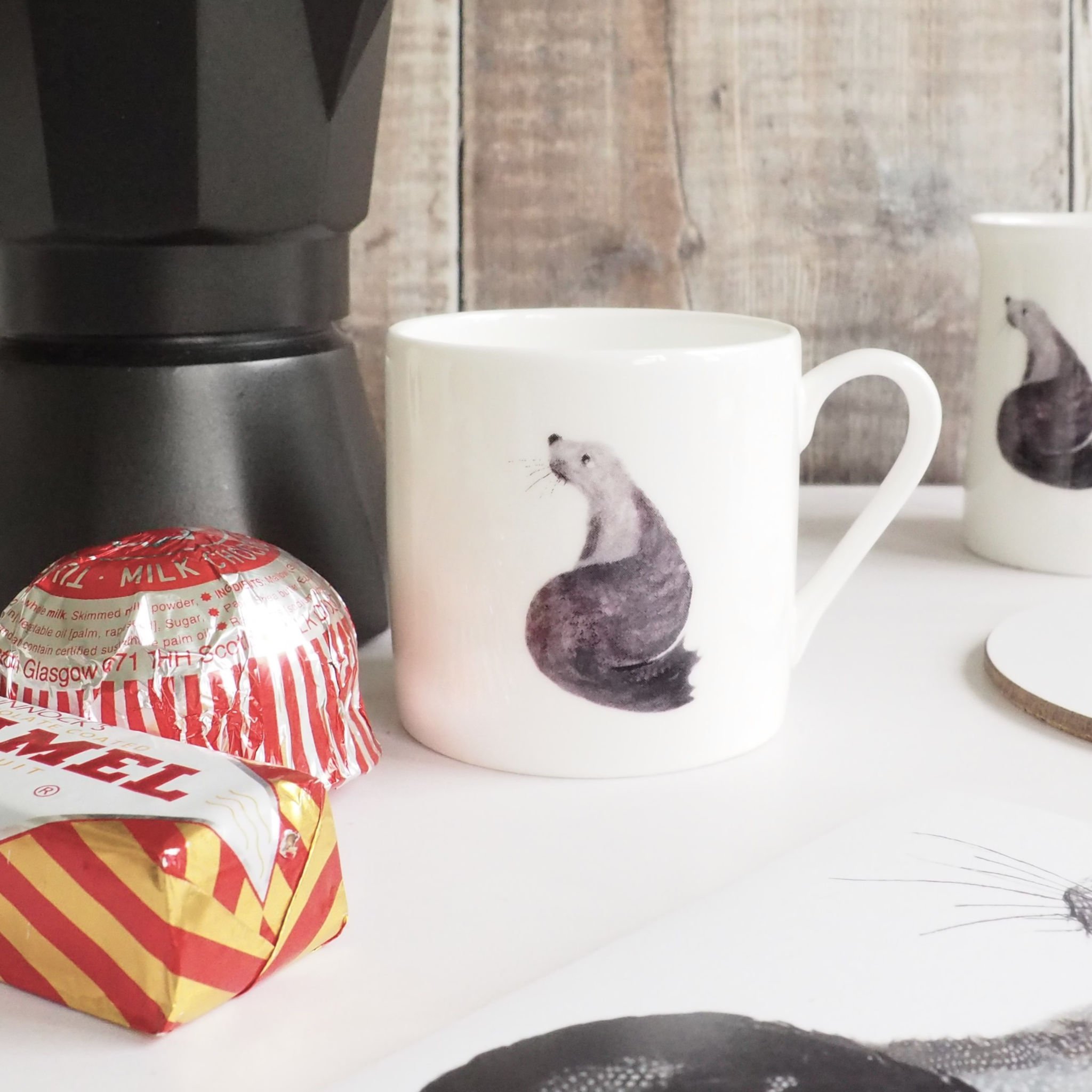 Seal Espresso Cup sized mini mug in white with a feather art black and grey perched Seal. Mug Chloe Gardner