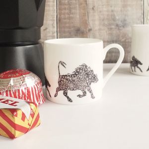 Black and white Warthog Espresso Mug by Chloe Gardner pictured with stovetop pot and Tunnocks teacakes