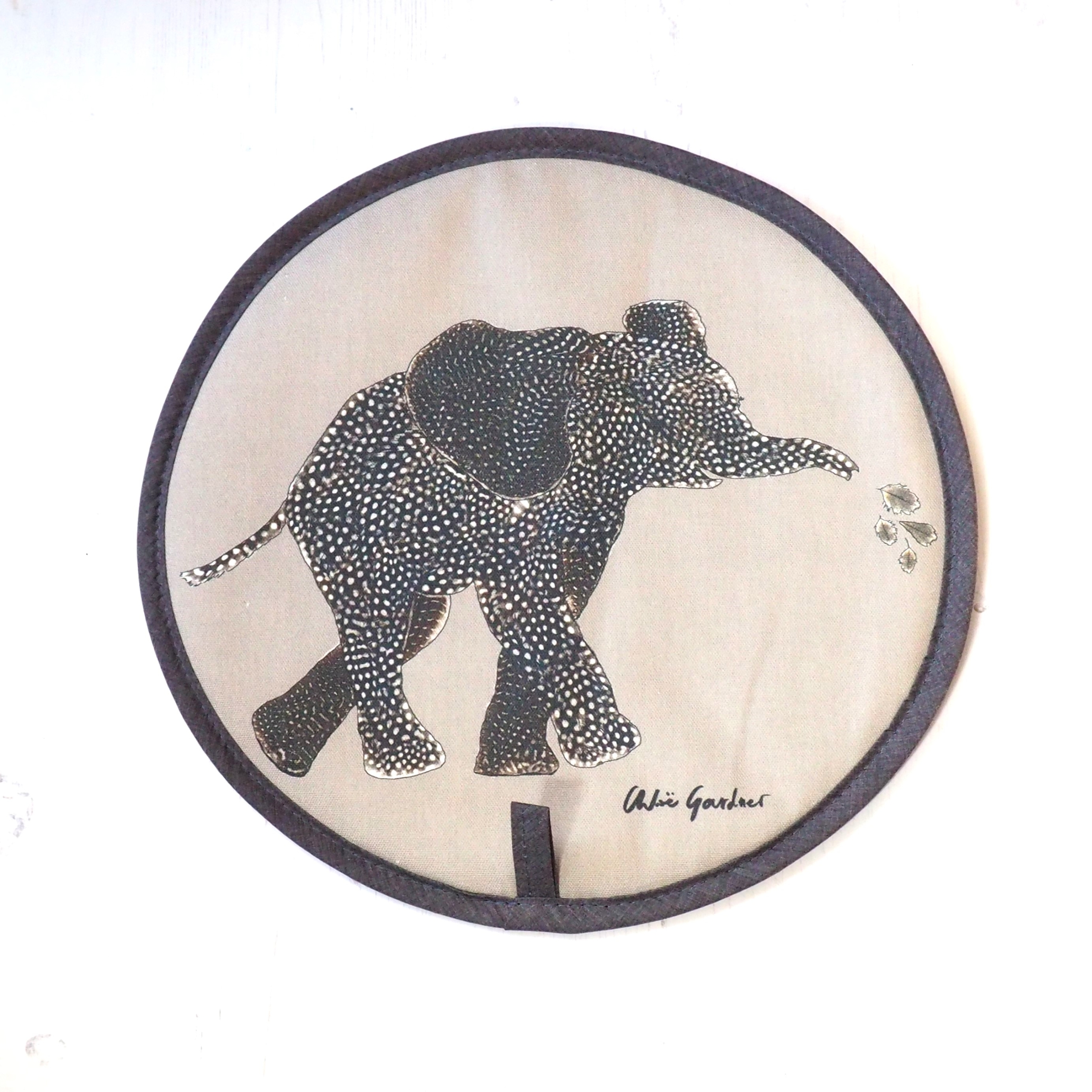 Elephant Aga cover facing right with spray Elephant Aga Cover made by Chloe Gardner with an elephant design in neutral tones. The elephant is facing right spraying water